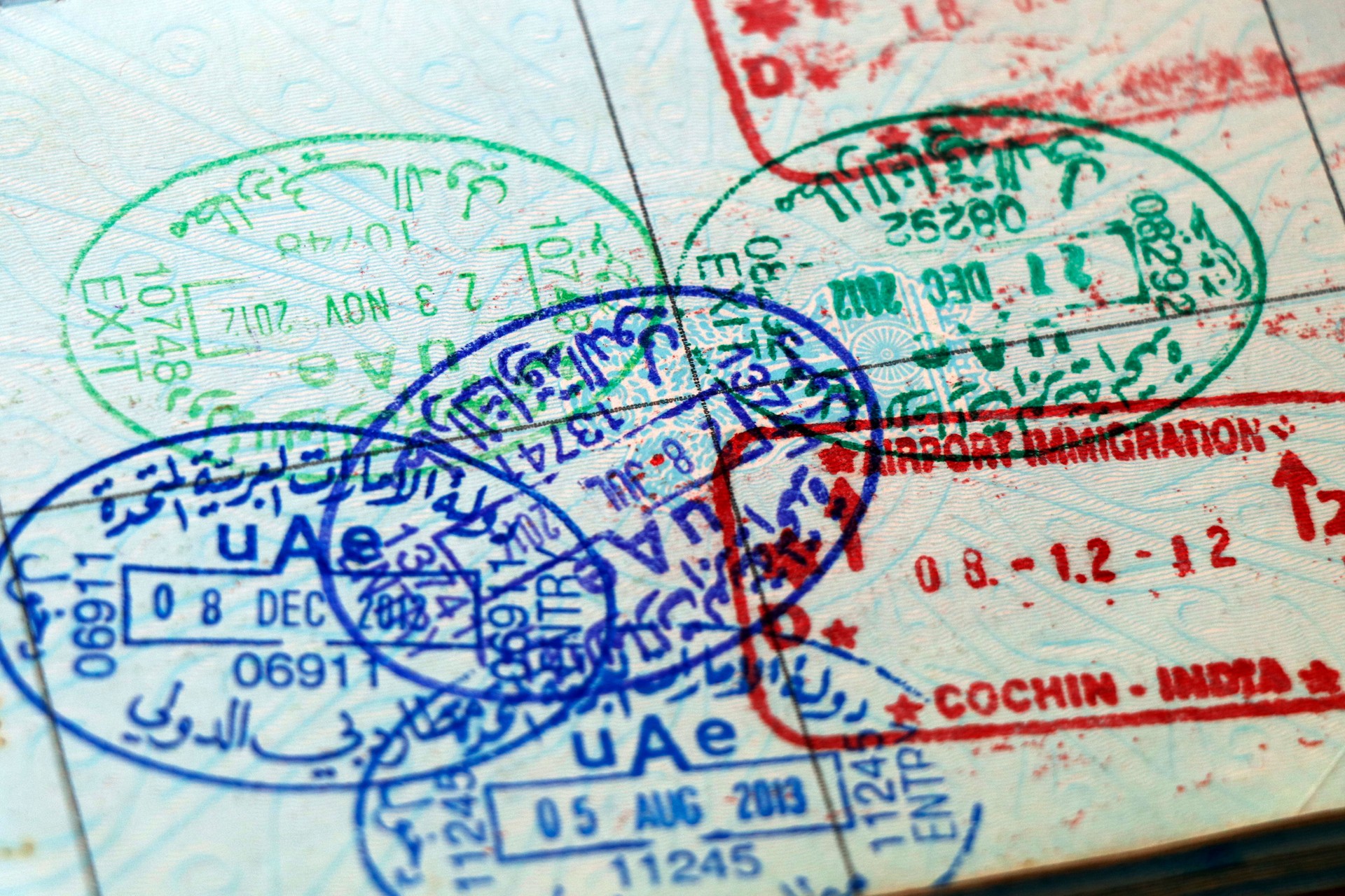 UAE visa stamping, united arab emirates and indian official stamps on a passport page, letters mentioned in arabic and hindi language also